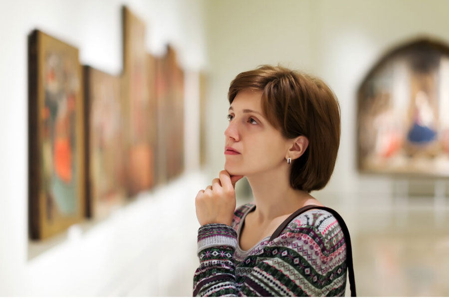 visitor-looking-pictures-in-art-gallery